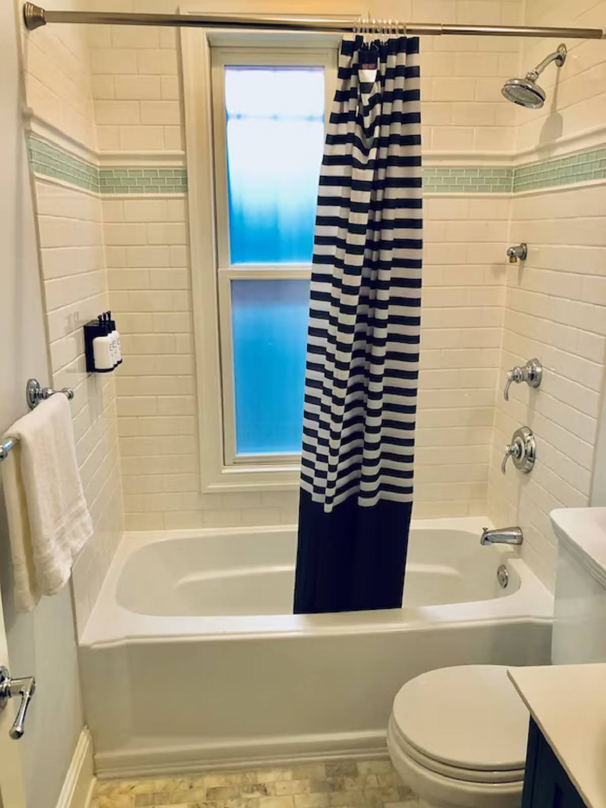 Full guest bathroom with tub and shower