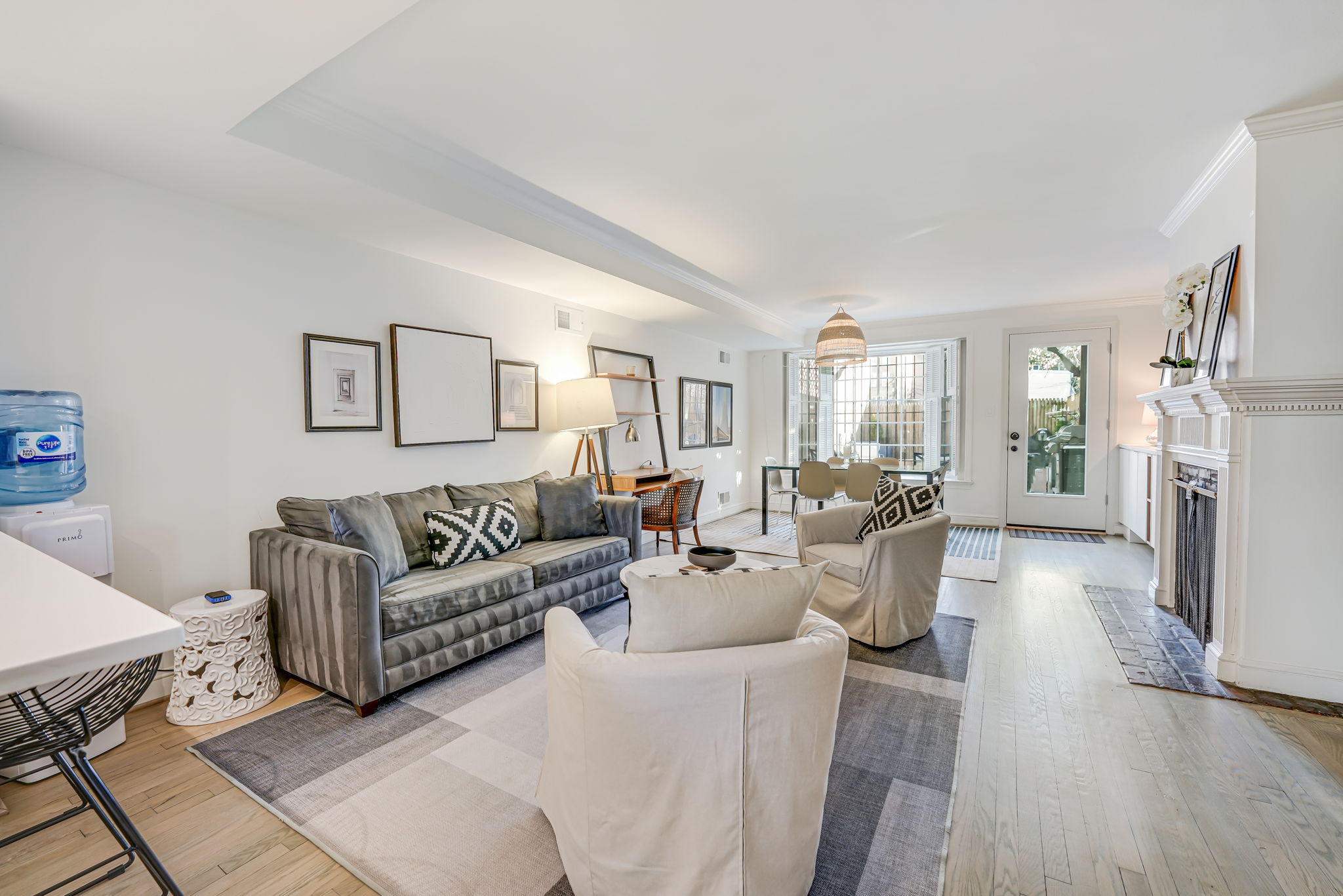 Open living and dining area with fireplace and bay window