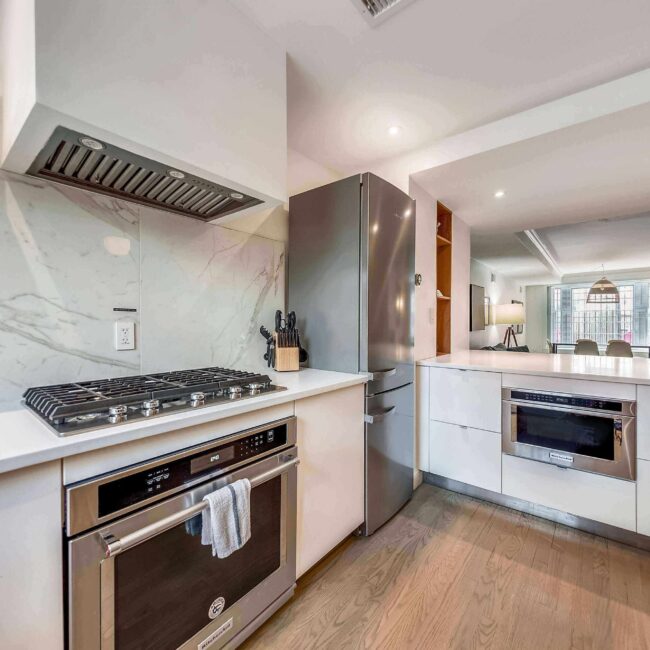 Kitchen featuring stainless steel KitchenAid appliances, gas cooktop, and vent hood.